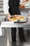 Waiter Placing Pasta Dishes On Tray