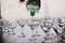 Waiter pouring martini in crystal glasses on table party at wedding reception. Martini row drinks at alcohol bar. Christmas and