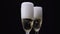 Waiter pours the champagne in two glasses. Black background. Close up