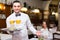 Waiter with prepared meal at table