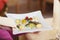 Waiter Presenting Dish At Restaurant Table