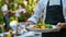 Waiter presenting gourmet salad with mozzarella and fresh vegetables