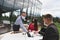 Waiter with protective medical mask and gloves serving guest