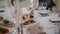 The waiter puts a plate of snacks on the wedding table close up