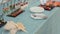 Waiter puts a tray with sushi on the table with snacks at a banquet