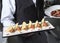 The waiter with the ready prepared dishes in the restaurant kitchen.