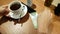 Waiter removes a cup of coffee from the table