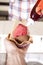 Waiter\'s Hand Pouring Strawberry Sauce On Ice Cream