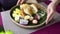 Waiter serve morning breakfast with tropical fruit, croissant, pancake and honey