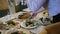 The waiter serves a festive table and puts plates of food on the table.