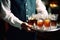 waiter serving club soda to guests at a soiree