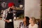 Waiter serving coffee and interacting with customers