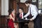 Waiter Serving Coffee To Tango Couple In Restaurant