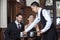 Waiter Serving Coffee To Tango Couple Sitting In Restaurant