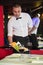 Waiter serving fruits and red wine on a table