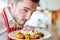 Waiter serving greek salad as a starter