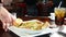 Waiter serving a plate of chicken pasta in a restaurant