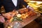 Waiter serving pork in luxury party in restaurant.