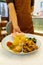 a waiter is serving a serving of nasi padang package.