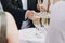 Waiter serving tray with champagne glasses for guests at wedding reception outdoors. Luxury life. Christmas and New Year feast