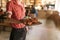 Waiter serving up a board of freshly baked nachos