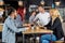 Waiter Serving Wine To Customers In Bar