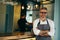 Waiter standing crossed arms in cafe bar