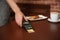 Waiter with terminal for contactless payment in cafe