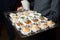 A waiter with a tray of snacks at a banquet