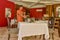 Waiter in uniform serving table in the restaurant at the tropical island