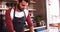 Waiter using laptop at counter