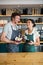 Waiter and waitress holding bowl with snack and coffee cup