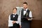 Waiter and waitress serving white wine