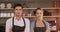 Waiter and waitress standing with their arms crossed