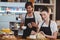 Waiter and waitress working behind the counter