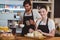 Waiter and waitress working behind the counter