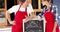 Waiter and waitresses standing with menu board