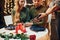 Waiter waits for payment. Young lovely couple have romantic dinner indoors together