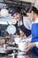 Waiter Working With Coworker At Counter In Ice Cream Parlor