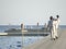 Waiters holding trays with glasses, view from the back - on water pontoon bridge in Samui, Thailand on March 5, 2010