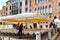 Waiters serve tables in outdoor restaurant in Venice, Italy