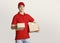 Waiting for parcel. Delivery man in uniform gives parcel at home
