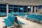 The waiting room at an empty airport. waiting room with metal chairs with sign for observing distance