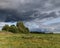 Waiting for a thunderstorm. There are clouds over the field.