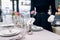 Waitress against empty tableware, table setting