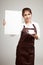 Waitress or barista in apron holding coffee and blank sign