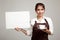 Waitress or barista in apron holding coffee and blank sign