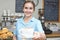 Waitress In Cafe Serving Customer With Coffee