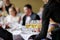 Waitress with dish of champagne glasses