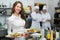 Waitress with food at kitchen